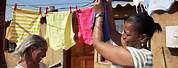 Black Person Hanging Clothes On Clothesline