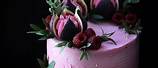 Cake Decorating with Purple Fruit and Flowers