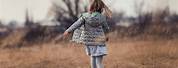 Little Girl Walking Away with Basket