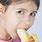 Of a Girl Eating Apple and Bananas