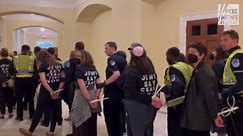 Pro-Palestinian Capitol Hill protestors chant 'not in our name' while in custody