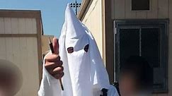 Student wears KKK garb for class project