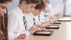 4k, Teenage school children with digital tablets in classroom