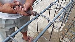 Workers are tying wires using pincer to form the foot plate foundation for the iron foundation of a high rise building