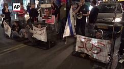 Protesters lock themselves in cages, blocking Tel Aviv road as they demand the release of hostages still held in Gaza.
