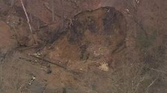 Fifty-foot hole formed after a clogged drainage pipe blew out due to pressure in Mullica Hill, NJ