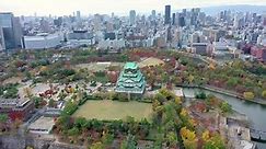 Aerial view 4k by drone of Osaka castle and building city at Osaka, japan in autumn.