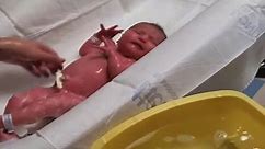 Newborn baby girl crying in hospital