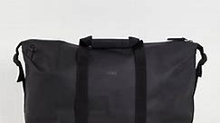 Rains 13200 unisex waterproof weekend duffel bag in black | ASOS
