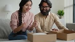 Happy Couple Customers Receive Parcel Look Inside Box Arabian Indian Man and Woman Open Delivery
