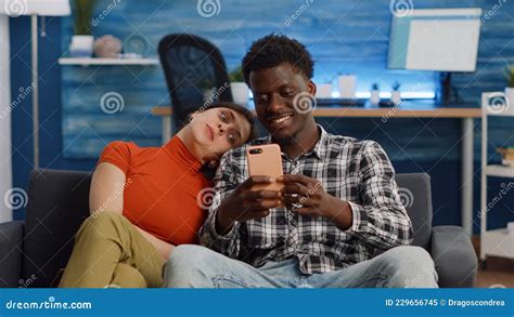 Joyful Interracial Couple Taking Selfies With Smartphone Stock Image