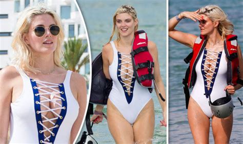 ashley james flaunts jaw dropping cleavage as assets pop out of risque lace up swimsuit