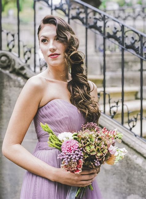 Bridesmaid In Purple With Long Wavy Side Swept Hair Style
