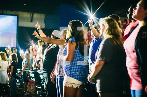 cheering fans   concert holding glowing photo lightstock