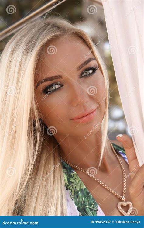 Woman With Blond Hair In Elegant Swimsuit Relaxing At Beach Stock Image