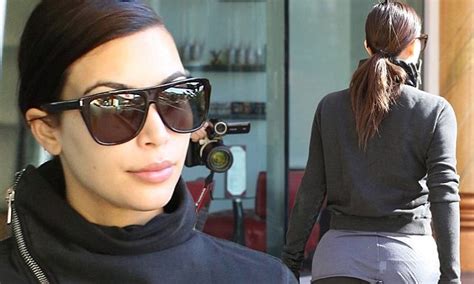 kim kardashian stretches her spandex to the limit as she covers her bottom for gym trip daily