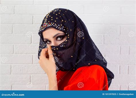 beautiful shy muslim woman covering face  fashion veil stock image