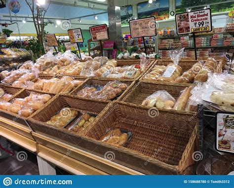 bagged bread  rolls displayed  baskets  supermarket aisle editorial image image