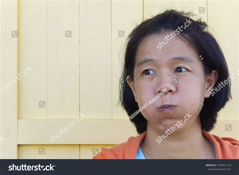 asian woman puffy cheeks by putting stock fotografie k okamžité
