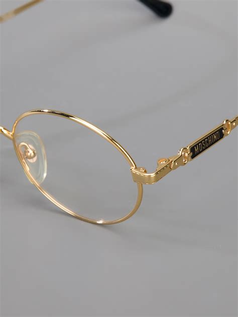 Lyst Moschino Round Frame Glasses In Metallic