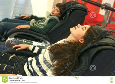 teen siblings brother and sister in massage chair stock