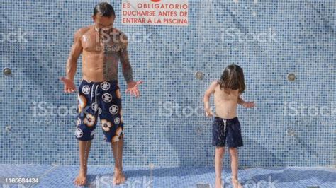Father And Son Following The Rules And Having A Shower Before Swimming