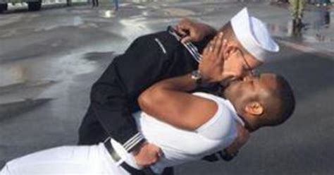 image of sailor kissing same sex partner after deployment sparks