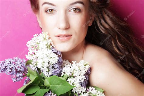Premium Photo Girl With Lilac Flowers Over Pink Background