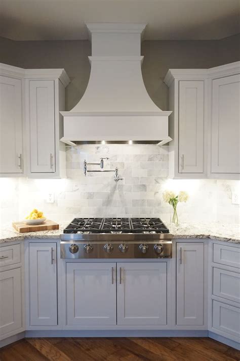 white cabinets shaker door inset cabinetry decorative range hood kitchen design small