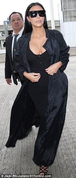 kim kardashian in a low cut black corset style dress in