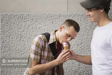 a gay couple sharing an icecream superstock