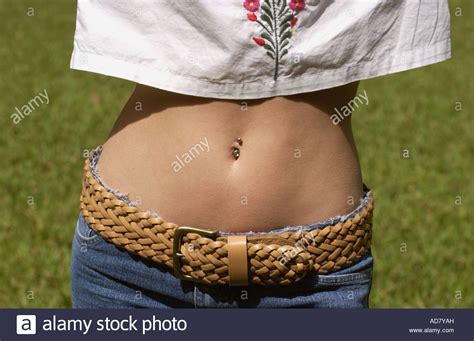 Woman Shows Her Bare Midriff With A Belly Button Ring