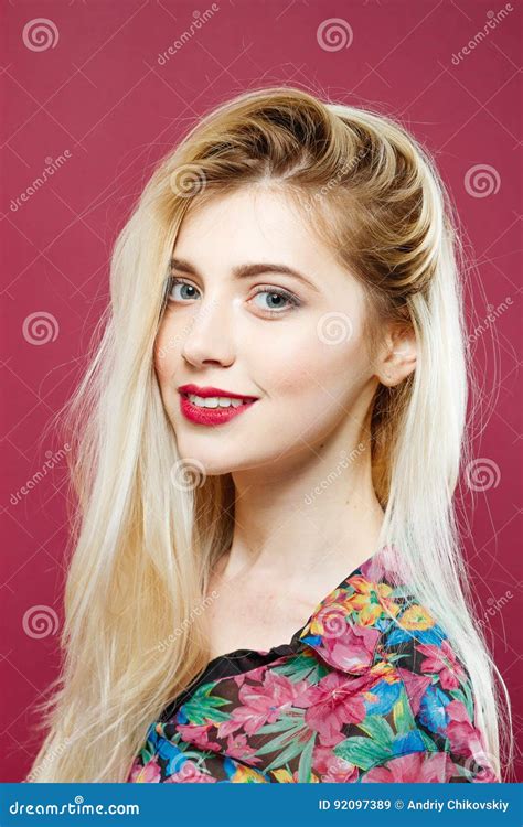 Portrait Of Amazing Blonde Looking At The Camera And Smiling On Pink