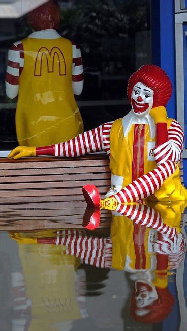 A Statue Of Ronald Mcdonald Sits Outside The Fast Food