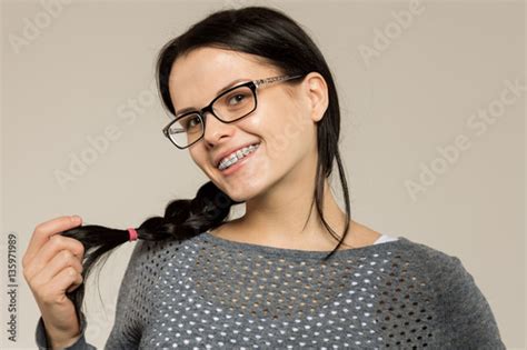 Photo Stock Nerd Girl In Glasses And With Brackets On Teeth Positive
