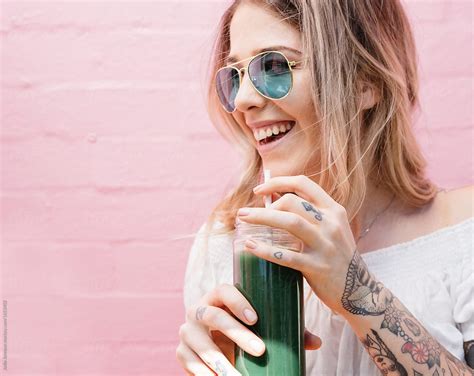View Happy Blonde Girl Drinking A Healthy Green Juice By Stocksy