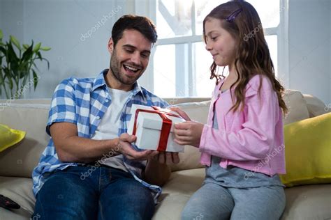father giving gift  daughter stock photo  wavebreakmedia
