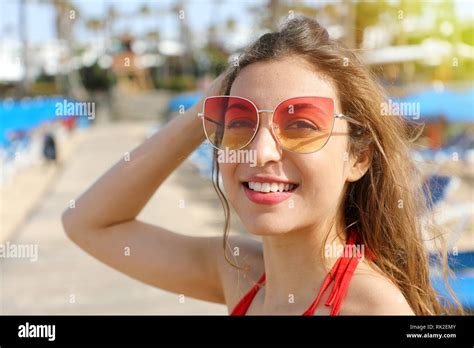 close up image of happy smiling brunette woman in sunglasses and bikini