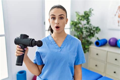 Young Physiotherapist Woman Holding Therapy Massage Gun At Wellness