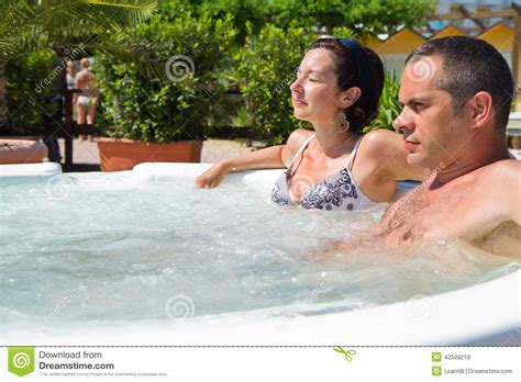 Happy Couple Relaxing In Hot Tub Vacation Stock Image
