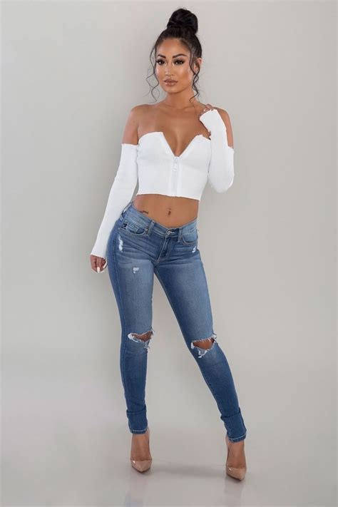 a ribbed knit crop top featuring an off the shoulder neckline zip up front and long sleeves