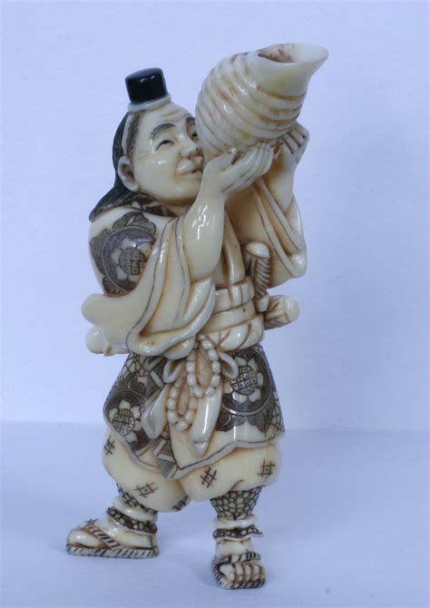netsuke of benki blowing his conch in hippo tooth ivory