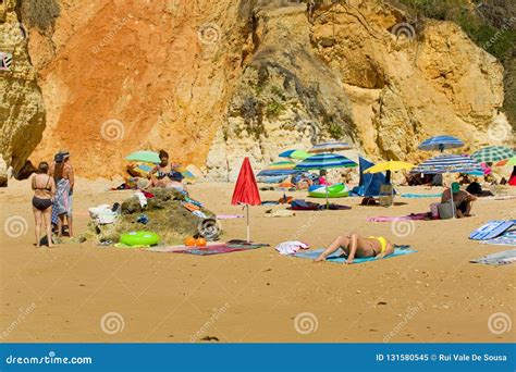 People At The Famous Beach Of Olhos De Agua In Albufeira Editorial