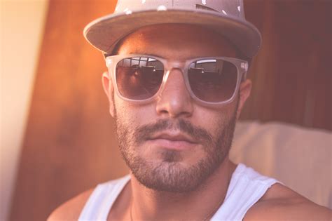 Man Wearing White Tank Top And Sunglasses Taking Close Up Selfie · Free