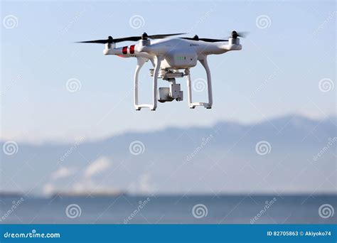 drone flying  clear blue sky editorial stock photo image  quadrocopter drone