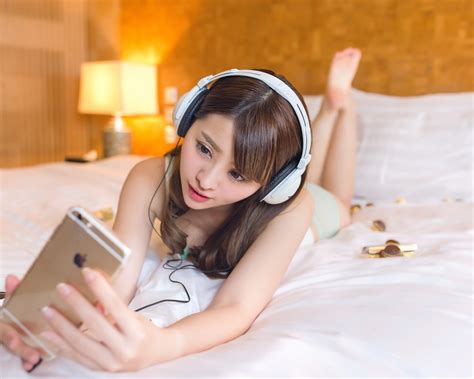 wallpaper asian girl in bed mobile phone headphones 1920x1200 hd picture image