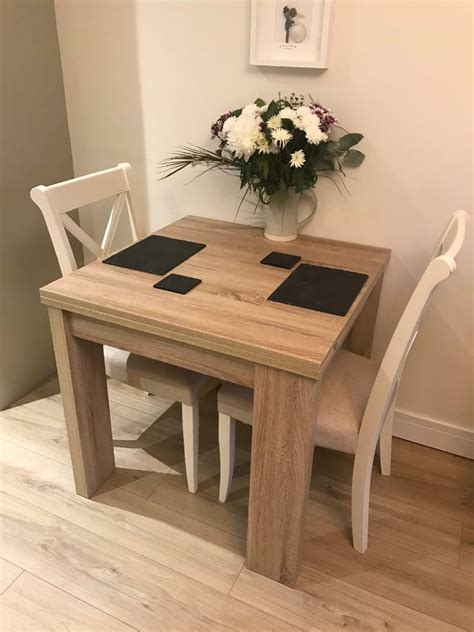 light oak extending dining table ivory chairs  brough east