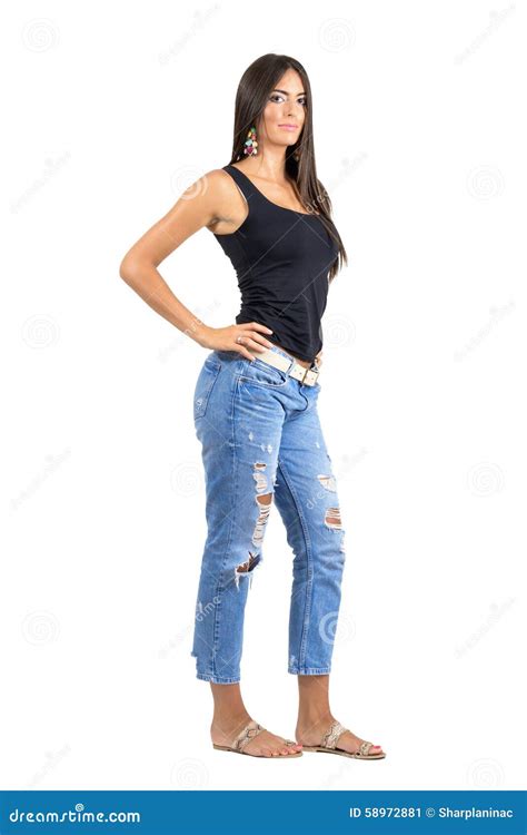 Side View Of Young Confident Hispanic Female Posing At Camera With Hand
