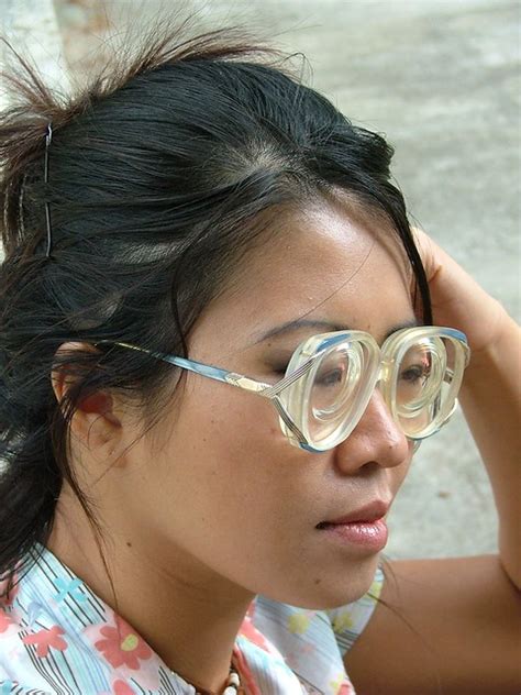 loony cute girl wearing some vintage large glasses with thick lenses