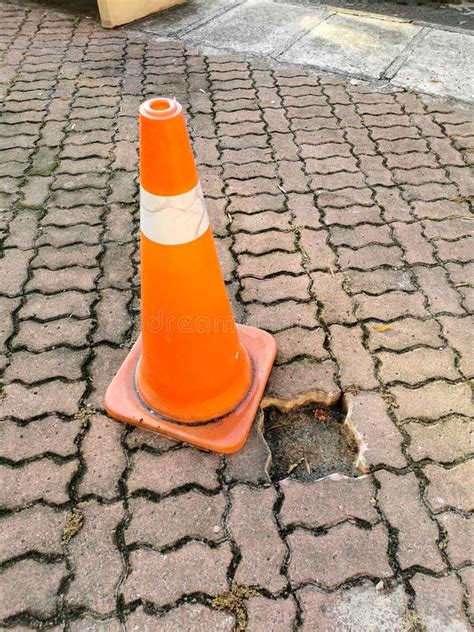 Traffic Safety Cone To Warn Missing Paver Bricks Floor Pathway